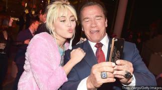 arnold-schwarzenegger-and-miley-cyrus-reunite-one-year-after-she-broke-up-with-his-son.jpg